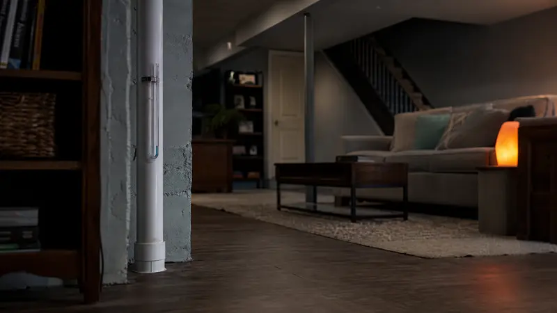 Basement apartment living area with a radon monitor